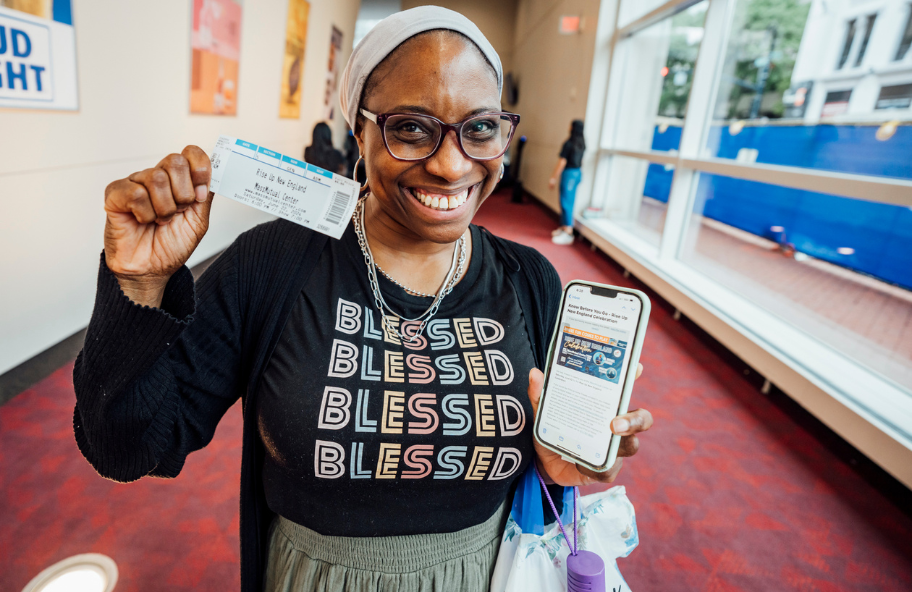 woman holding AWAKE Rally ticket